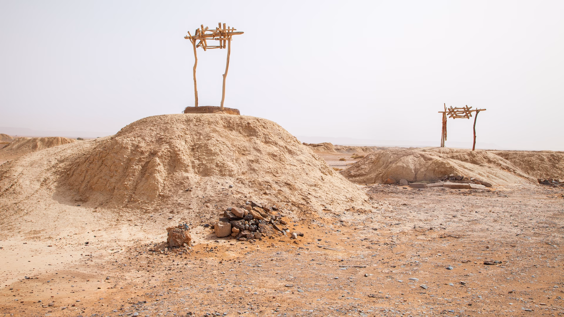 Mother wells of a khettara rising from the dry ground